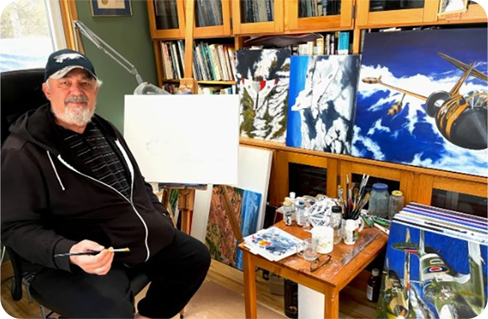 Adam in studio with surrounded by paintings