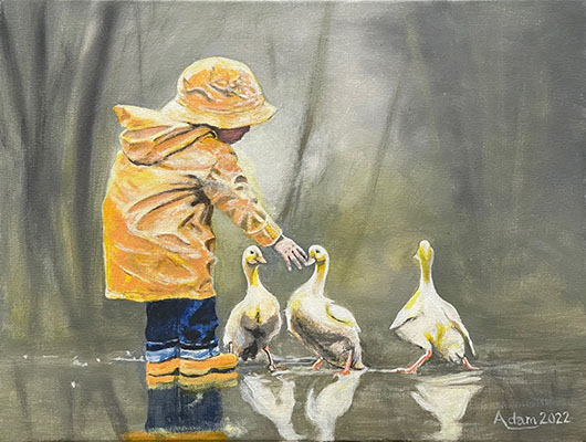 A little boy and 3 ducks